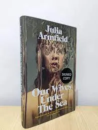Our wives under the sea front cover. A woman is shrouded by running water that pours over her face and shoulders.